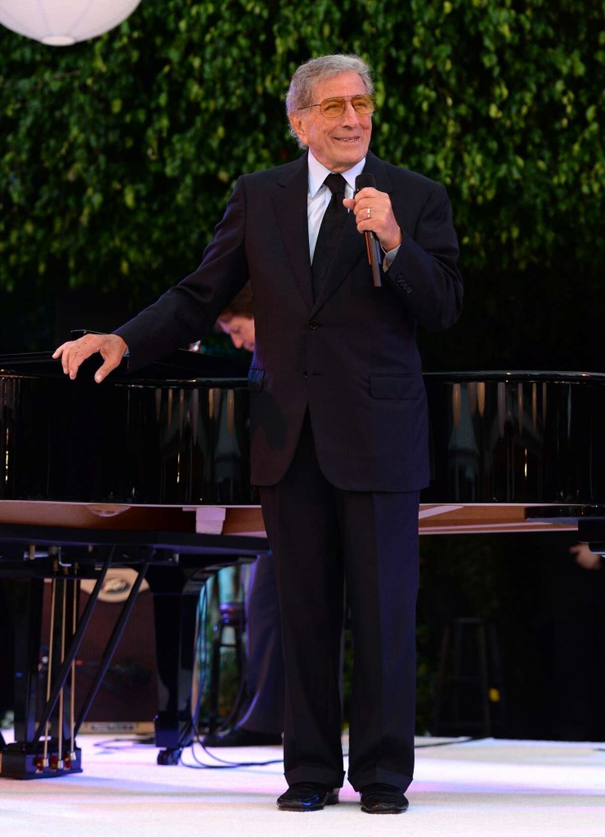 Singer Tony Bennett performs during the 87th birthday celebration of Tony Bennett and fundraiser for Exploring the Arts, the charity organization founded by Mr. Bennett and wife Susan Benedetto, hosted by Ted Sarandos & Nicole Avant Sarandos among celebrity friends and family on August 3, 2013 in Beverly Hills, California.