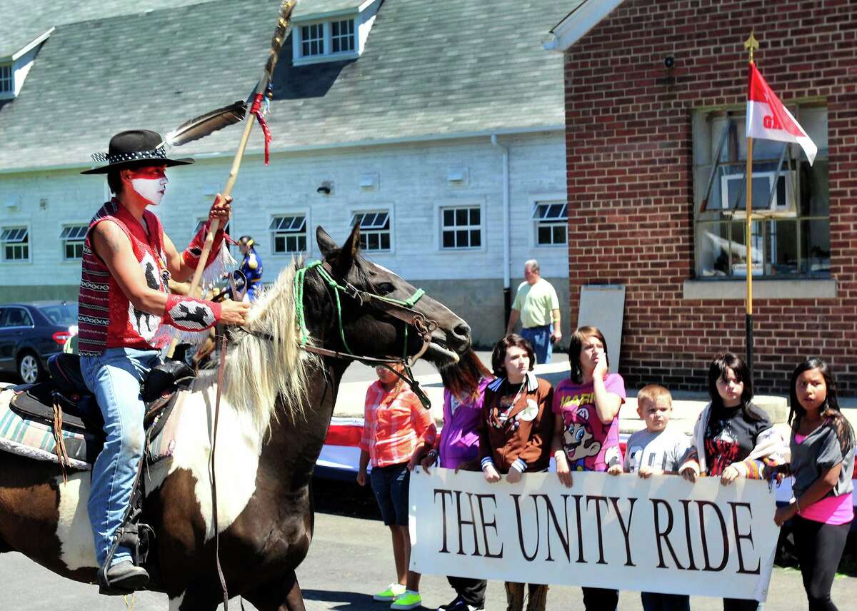 Sioux ride with horse guard in Newtown