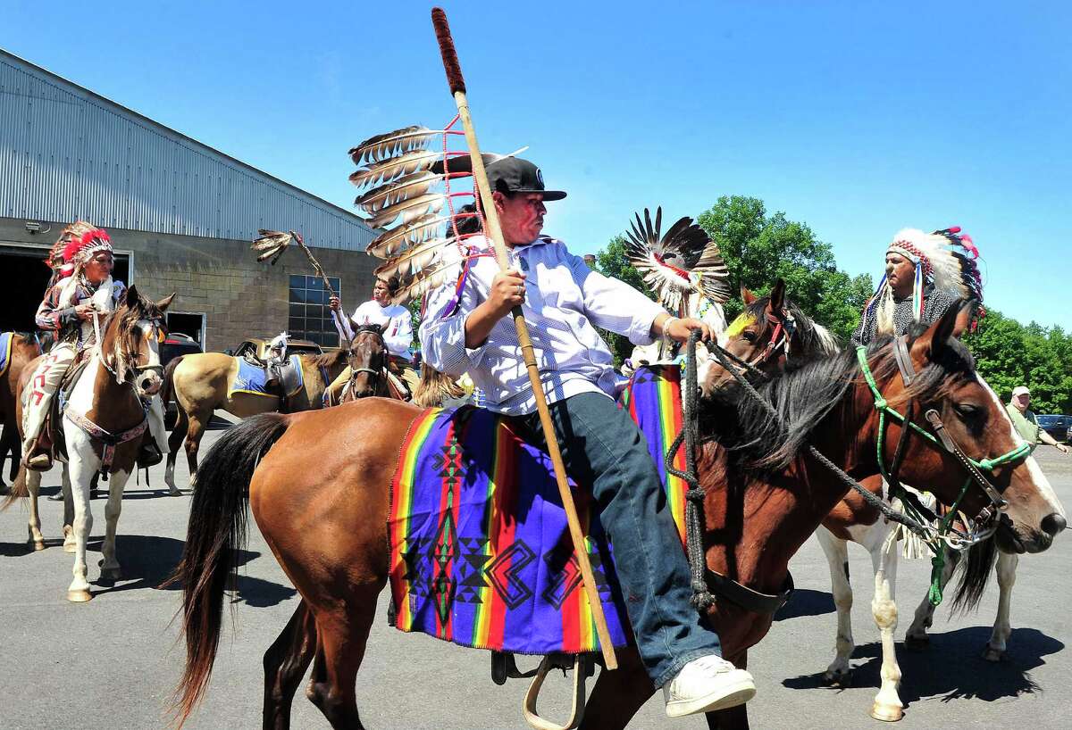 Sioux ride with horse guard in Newtown