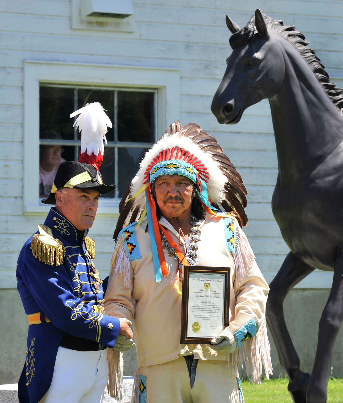 Sioux ride with horse guard in Newtown