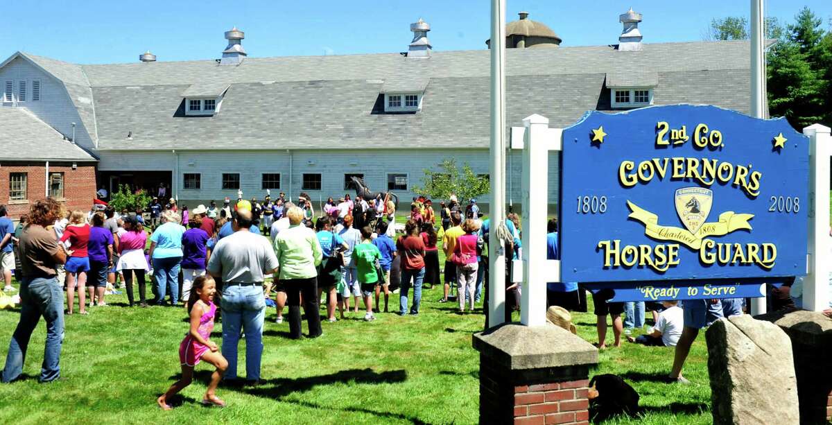 Sioux ride with horse guard in Newtown