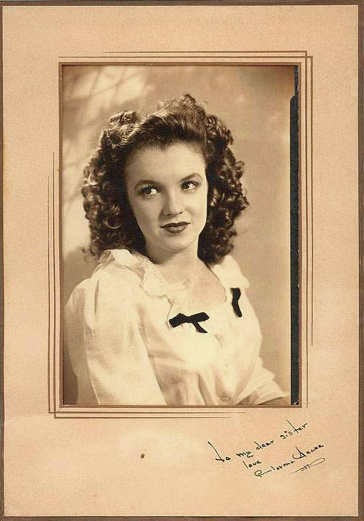The vintage portrait of Norma Jean Dougherty, also known as actress Marilyn Monroe, with a rare autograph and dedication "To my dear sister," is on display in this undated photo for Sotheby's 2001 online auction of articles from the collection of Monroe's half-sister, Bernice Miracle.
