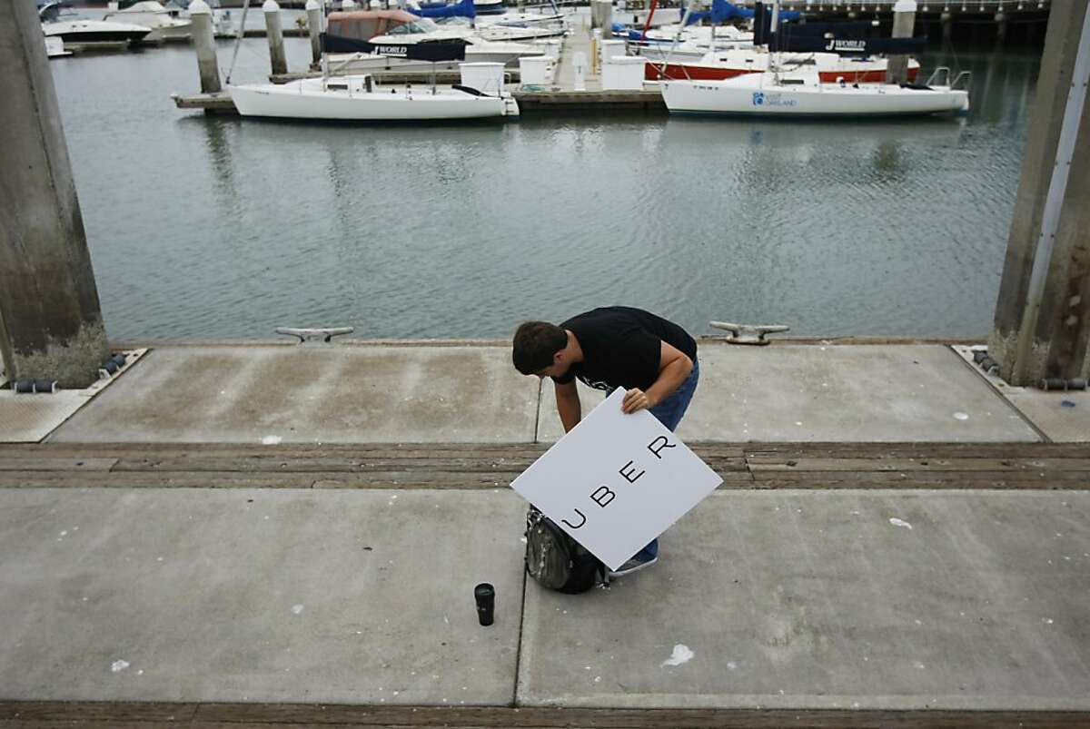 Uber operations manager, Rian Tolkin, picks up his stuff at the jetty at Jack London Square where Uber and Boatbound teamed up to provide a worker commute service to San Francisco in the event of a BART strike on Monday, August 05, 2013 from Oakland, Calif.