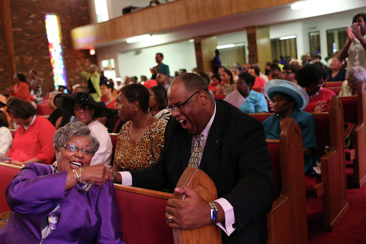 Phillis Morrison, the wife of pastor Rev. David L. Morrison, Sr., laughs with Alonzo Lunsford at St. Luke AME Church in Fayetteville, NC on Sunday, July 21, 2013.
