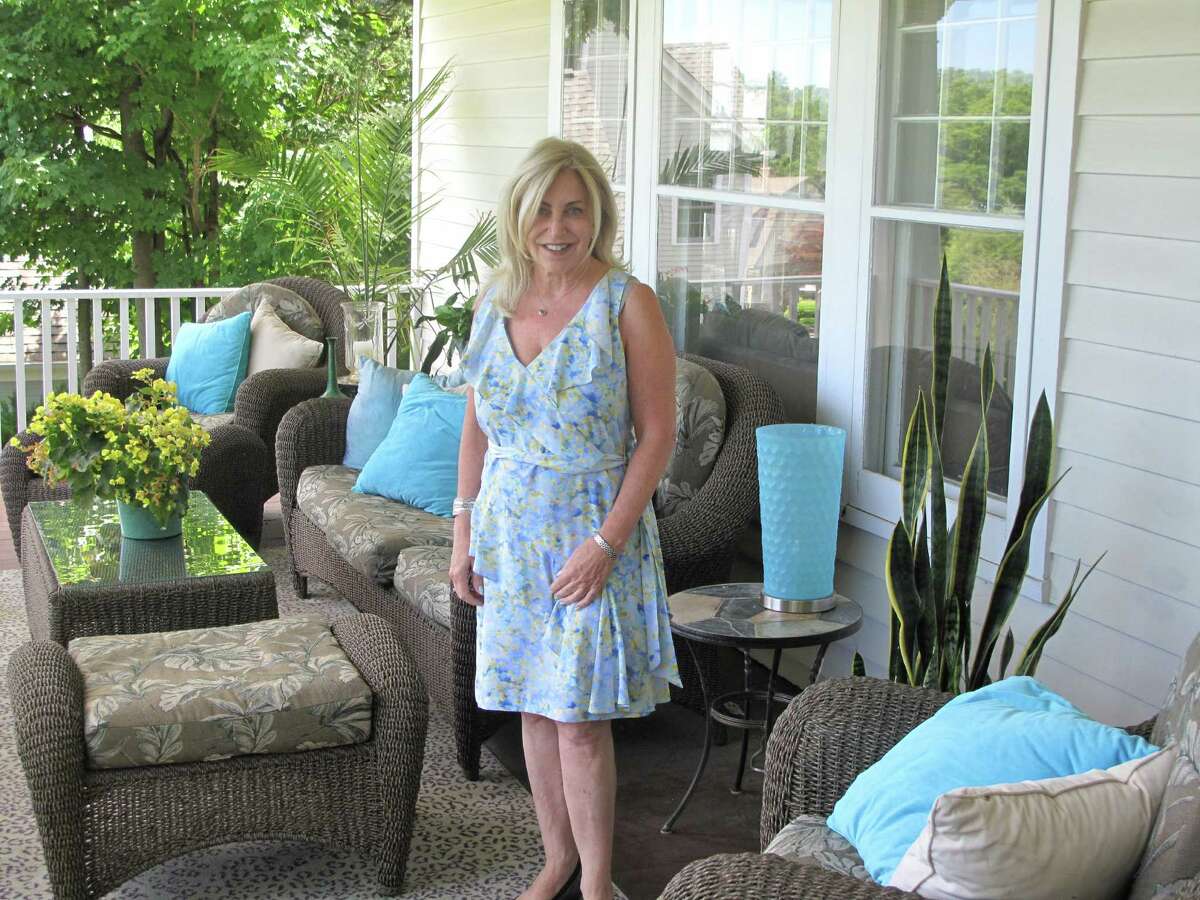 Denise Gannalo on her porch at 275 Main Street, New Canaan. The porch serves as a gathering spot for family and friends on Memorial Day.