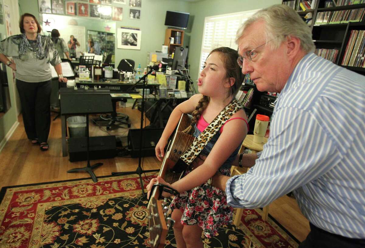 Voice coach Tom McKinney shows young country singer Collette Bruhn, 12, how to get the maximum effect from her voice.