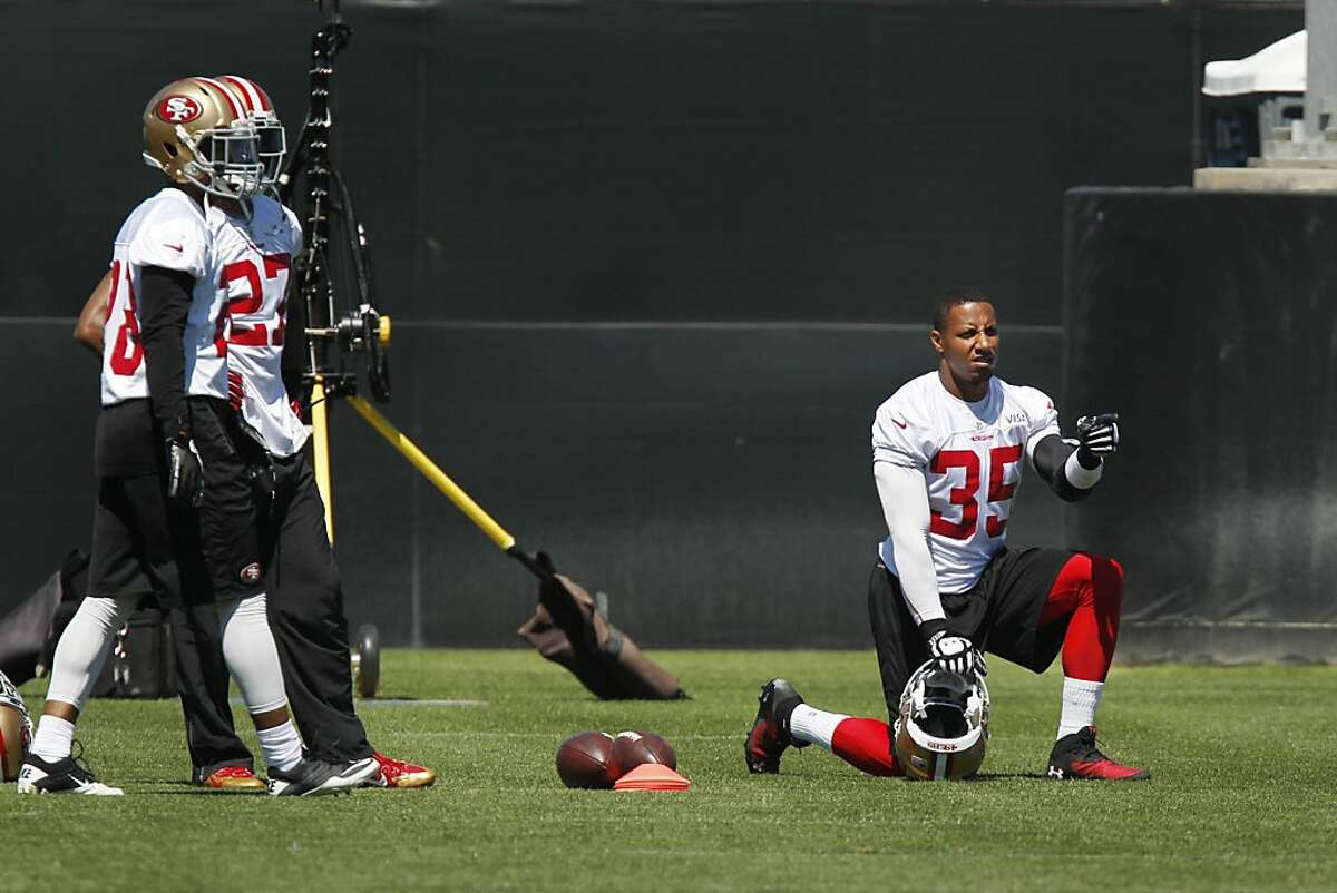 Eric Reid (right) #35 watches teammates practice during 49er team practice at the 49ers Training Facility on Thursday, June 13, 2013 in Santa Clara, Calif.