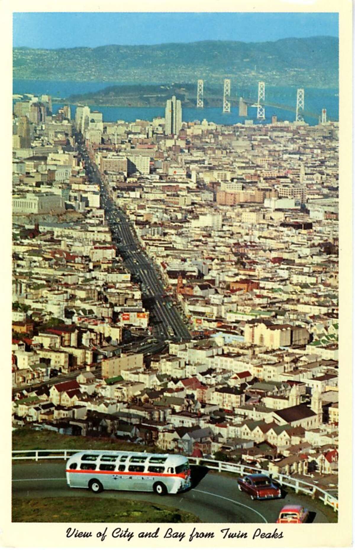 Vintage postcard showing a bird's eye view of San Francisco and the Bay. The San Francisco-Oakland Bay Bridge is visible in the distance.