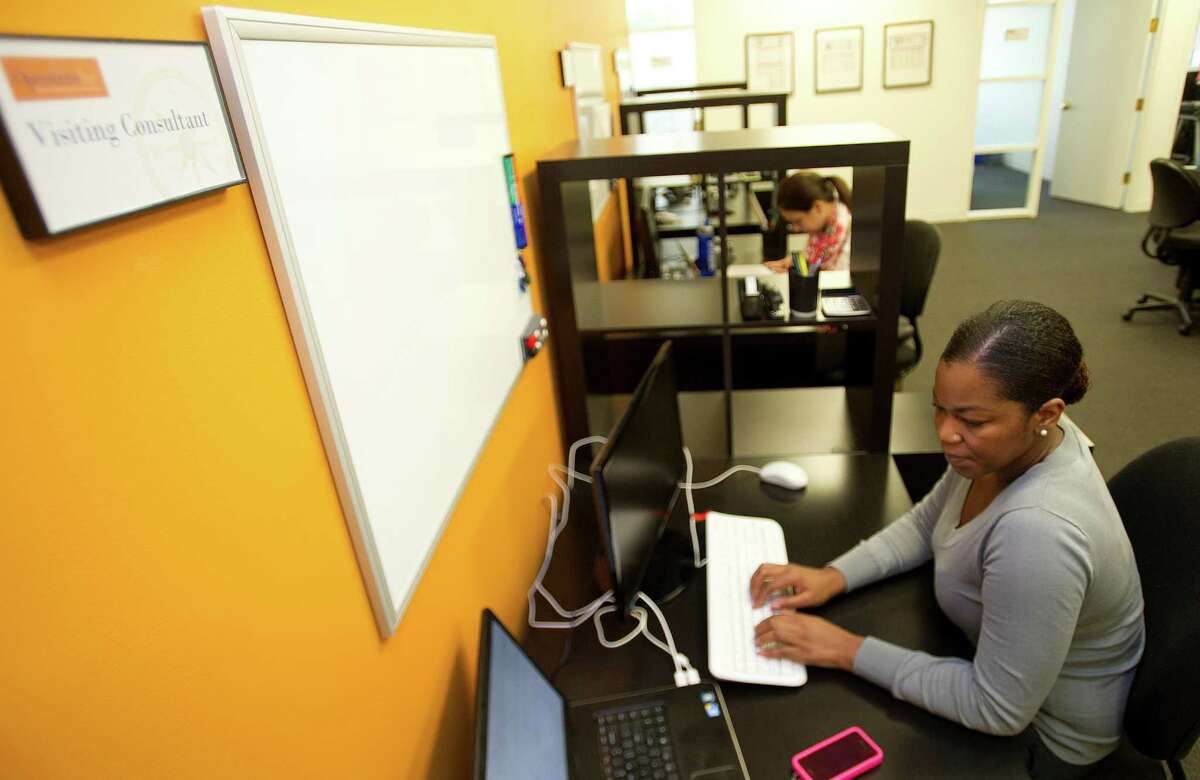 Rita Lutterodt, Human Resources Generalist Consultant, front, and Alexandra Lewis, Intern, work at OperationsInc in Norwalk, Conn., on Tuesday, August 6, 2013.