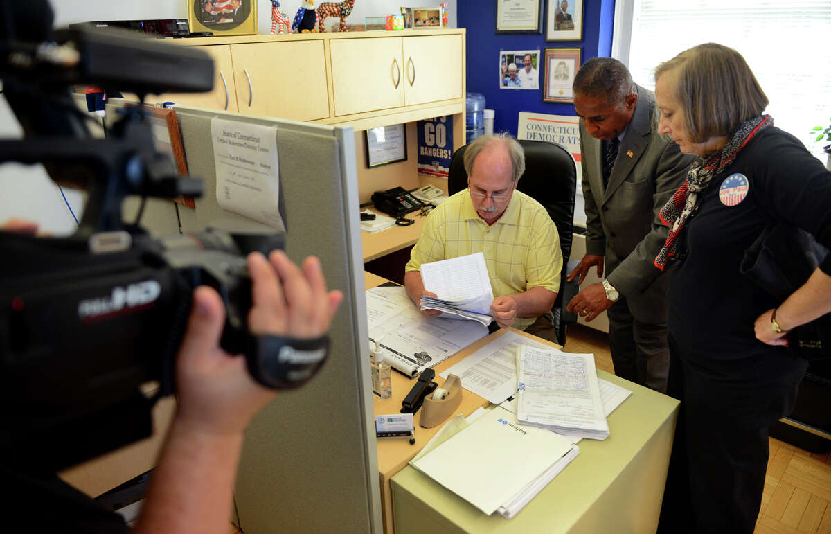 Democratic Mayoral candidate Joe Paul delivers the required petitions to run for mayor to Democratic Registrar of Voters Rick Marcone at Stratford Town Hall in Stratford, Conn. on Tuesday August 6, 2013. At right is Paul's Campaign Manager Terry Masters.