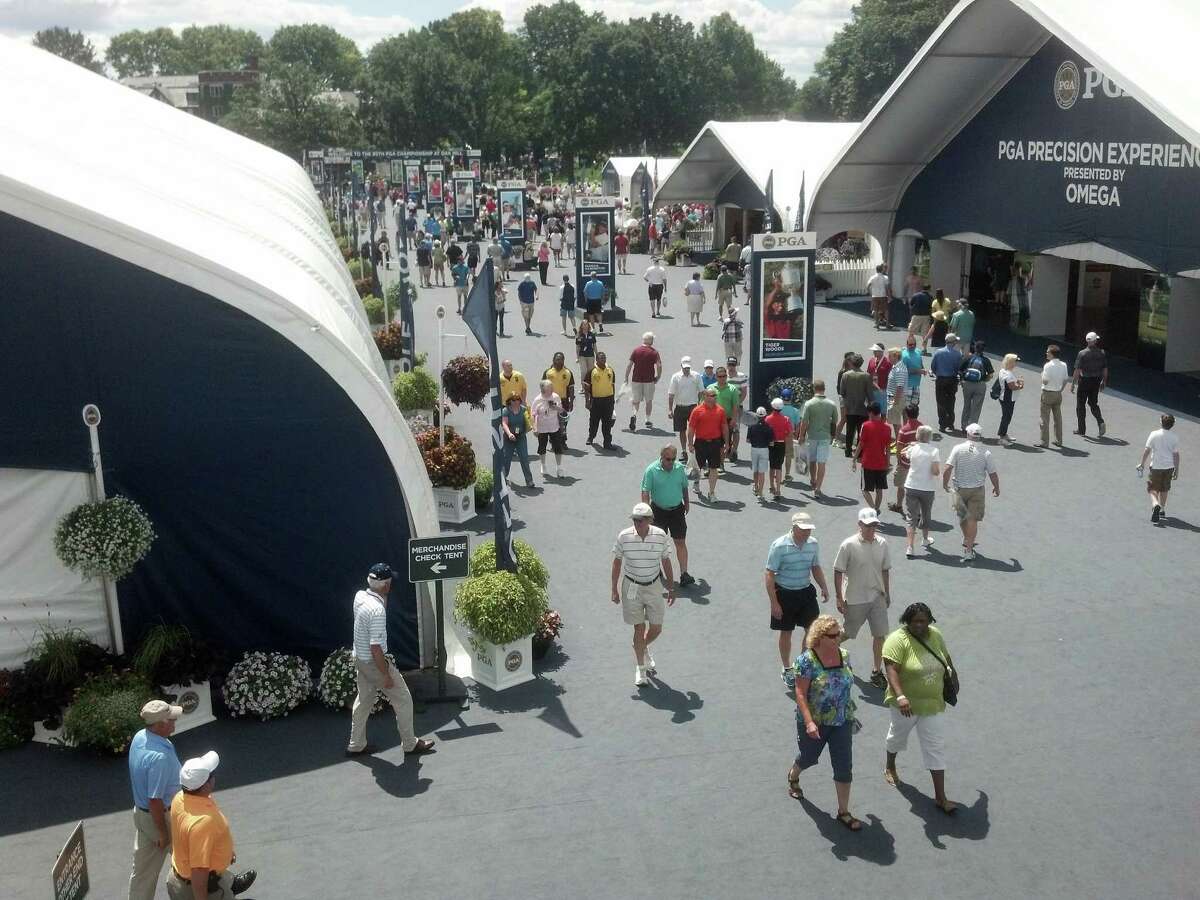 Golf fans mill around the permeter of the Oak Hill Country Club during the PGA Championship. That's the 32,000-square-foot merchandise tent on the left. (Pete Dougherty/Times Union)