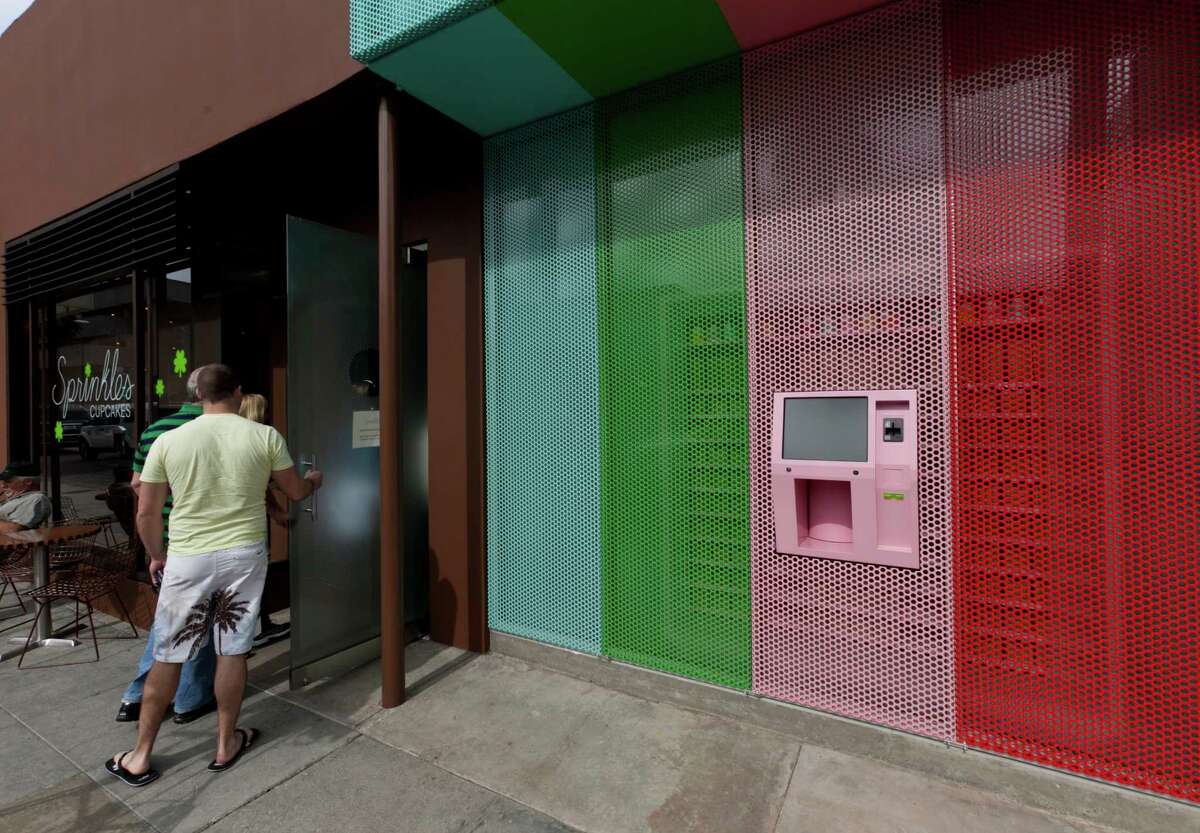 Sprinkles' first Cupcake ATM in Beverly Hills, seen in this March 5, 2012, photo, features a touchscreen and a robotic arm that pulls the correct flavor of cupcake from a wall of single-serving boxes inside the store. (AP Photo/Damian Dovarganes)