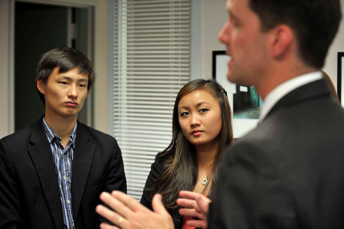 Stephen Song and his sister, Julianna, listen to Rep. Jim Himes speak during the Congressional Award ceremony reception at the congressman's office at the Stamford Government Center on Wednesday, Aug. 7, 2013. The Congressional Award recognizes people from the ages of 14 to 23 that achieve a certain number of hours in the different program areas: giving voluntary public service, working on personal development, working on physical fitness and organizing an expedition or exploring a new environment. Stephen was awarded the silver medal and Julianna was awarded the bronze medal.