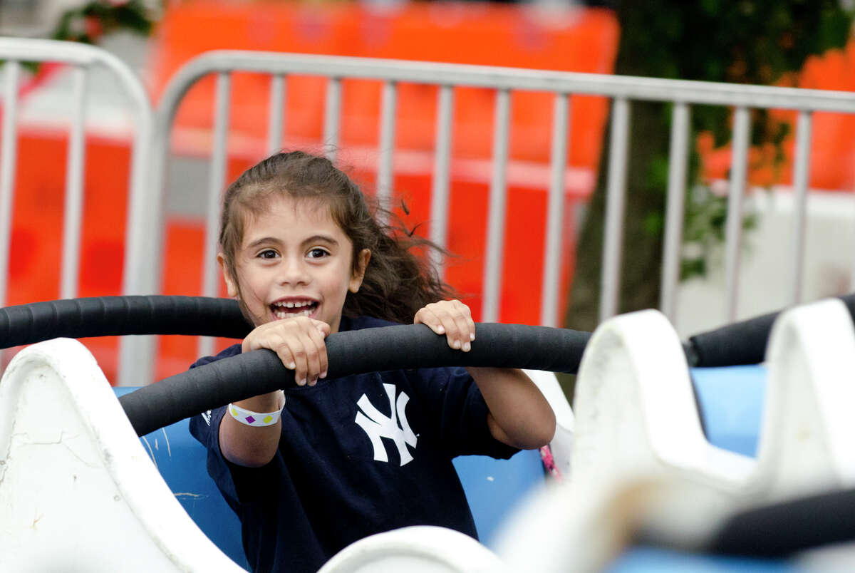 Daniela Mutis, 7, of Greenwich, rides the Himalaya carnival ride during opening night of the annual St. Roch Feast at St. Roch Church in Greenwich on Wednesday, Aug. 7, 2013 and ran through Saturday Aug. 10, 2013.