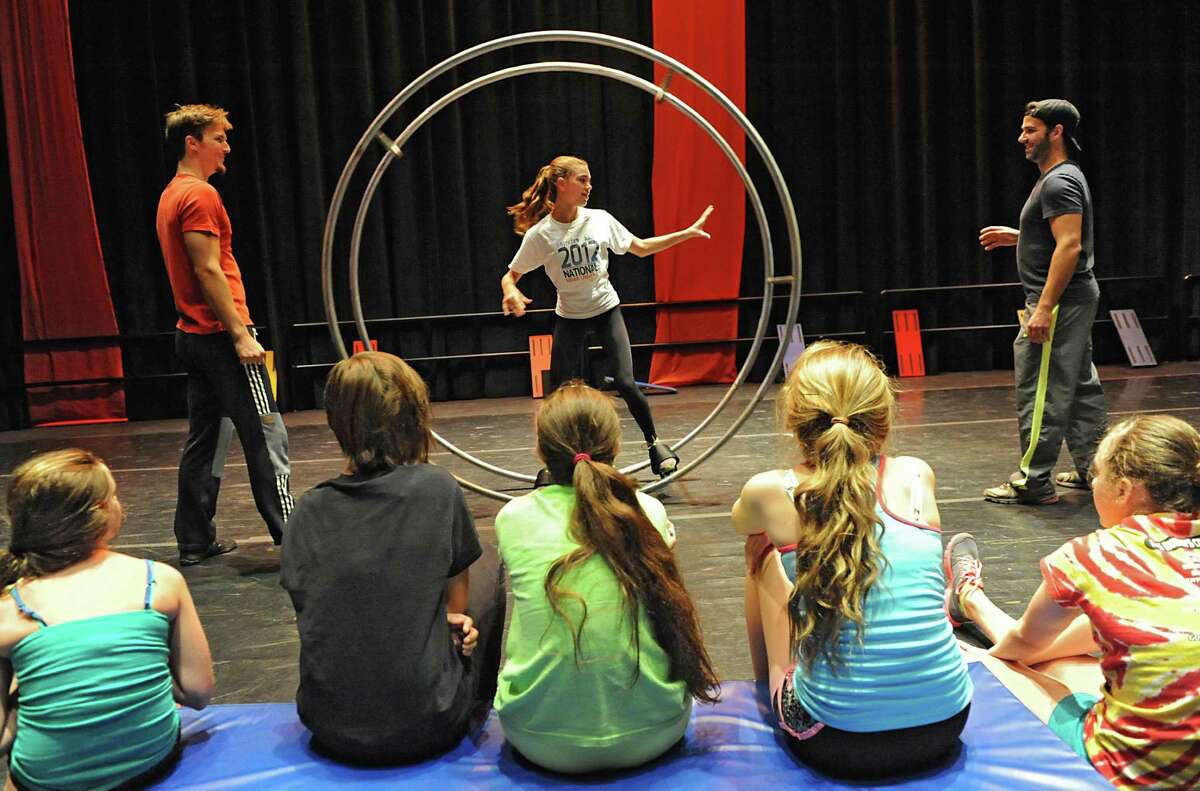 Alexa Pazienza, 13, of Clifton Park gets some help from instructors Frederick Lemieux-Cormier, left, and Nicolas Boivin, both of Montreal, on the German Wheel during Cirque Eloize circus school Monday, Aug, 5, 2013, at the GE Theatre at Proctors in Schenectady, N.Y. (Lori Van Buren / Times Union)