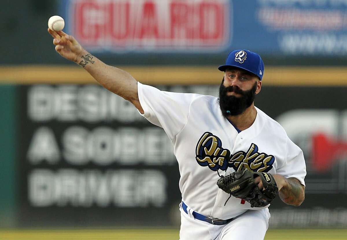 Former San Francisco Giants pitcher Brian Wilson makes his Los Angeles Dodgers organization debut in a baseball game for the A-level Rancho Cucamonga Quakes against the Lake Elsinore Storm, Wednesday, Aug. 7, 2013, in Rancho Cucamonga, Calif. (AP Photo/Alex Gallardo)