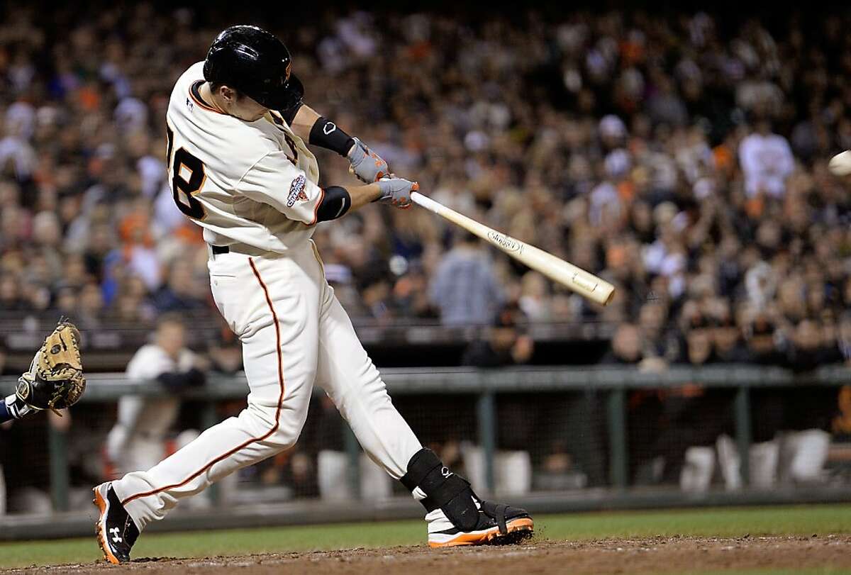 SAN FRANCISCO, CA - AUGUST 07: Buster Posey #28 of the San Francisco Giants hits a sacrifice fly scoring Brandon Crawford #35 in the seventh inning against the Milwaukee Brewers at AT&T Park on August 7, 2013 in San Francisco, California. (Photo by Thearon W. Henderson/Getty Images)
