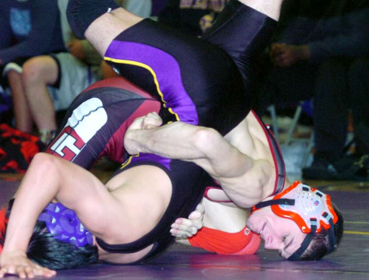 Greenwich's Dan Maxwell flips Westhill's Ariel Godoy in the 125 pound division as Westhill High hosts Greenwich in a wrestling match Wednesday, January 20, 2010. Maxwell won the bout.