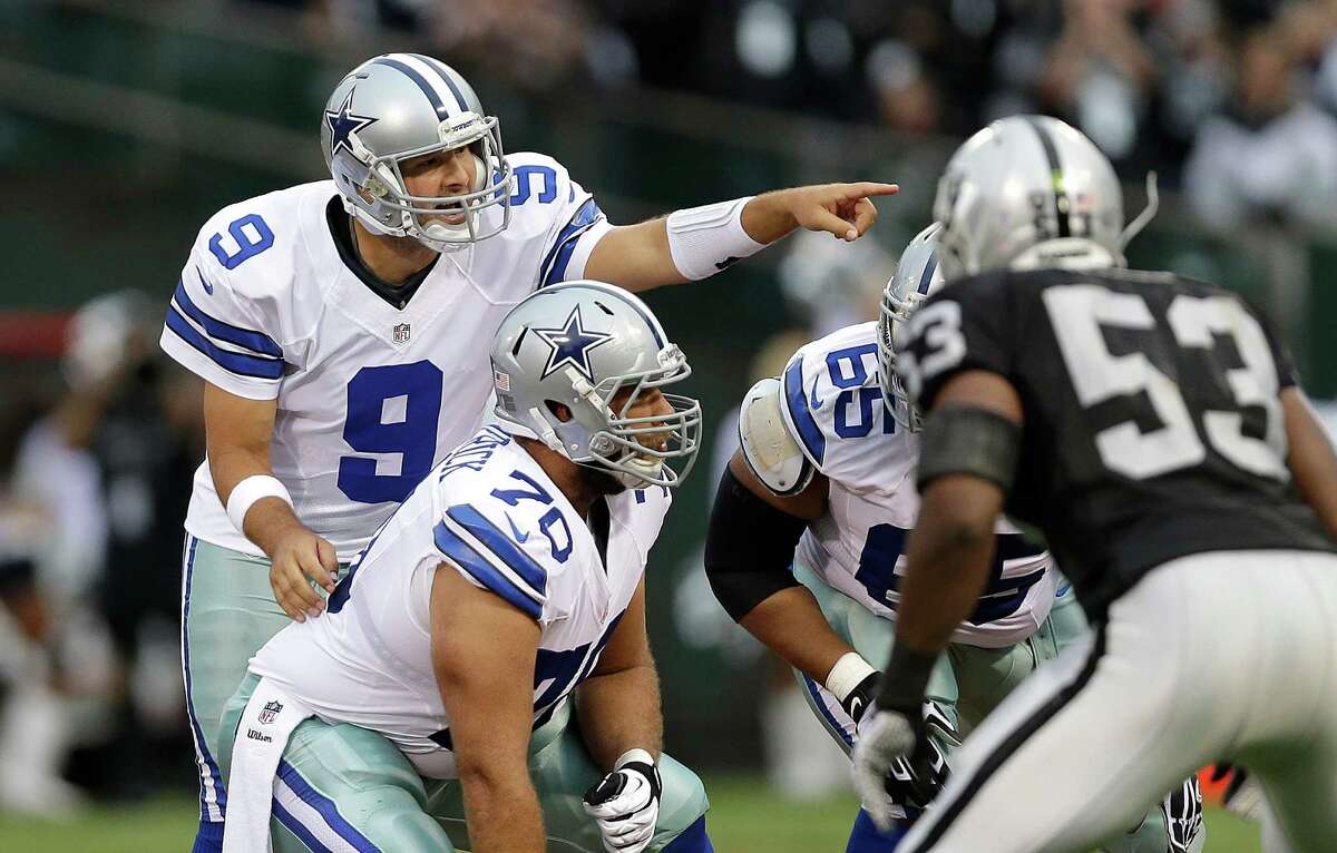 Dallas Cowboys quarterback Tony Romo (9) signals at the line of scrimmage during the first quarter of an NFL preseason football game against the Oakland Raiders in Oakland, Calif., Friday, Aug. 9, 2013. (AP Photo/Marcio Jose Sanchez)