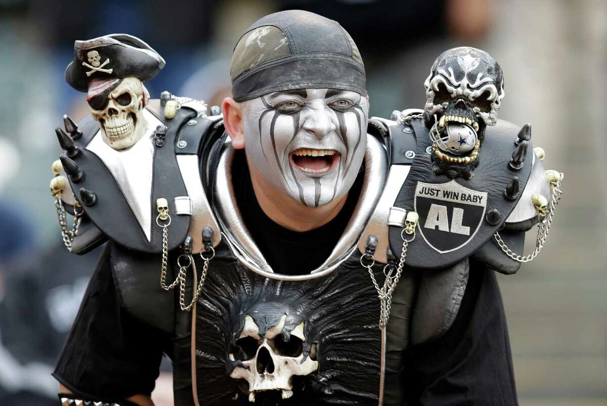 Oakland Raiders fan smiles during an NFL preseason football game between th...