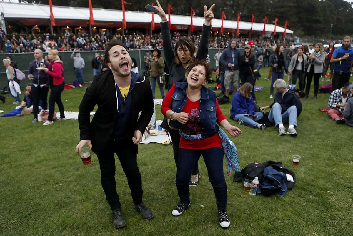 Brian Gilmore, Akiko Thomas (back) and Ada Gilmore sing along and dance to "Eight Days a Week" during Paul McCartney's performance at the Outside Lands Festival in San Francisco, Calif. on Friday, August 9, 2013.