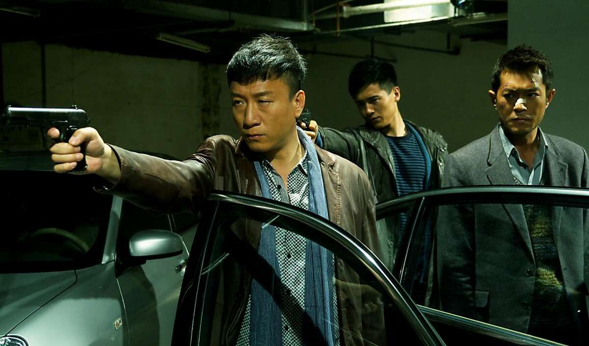Captain Zhang (Sun Honglei, left) makes a point as informant Timmy Choi (Louis Koo, right) watches in Johnnie To's DRUG WAR.