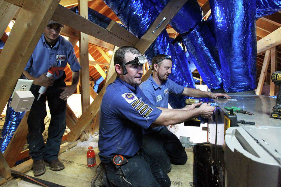 Installing Air Conditioners Is One Hot Job San Antonio Express News Jeremy Blalock Center Is Soaked In Perspiration While He Works With Jay Thomas