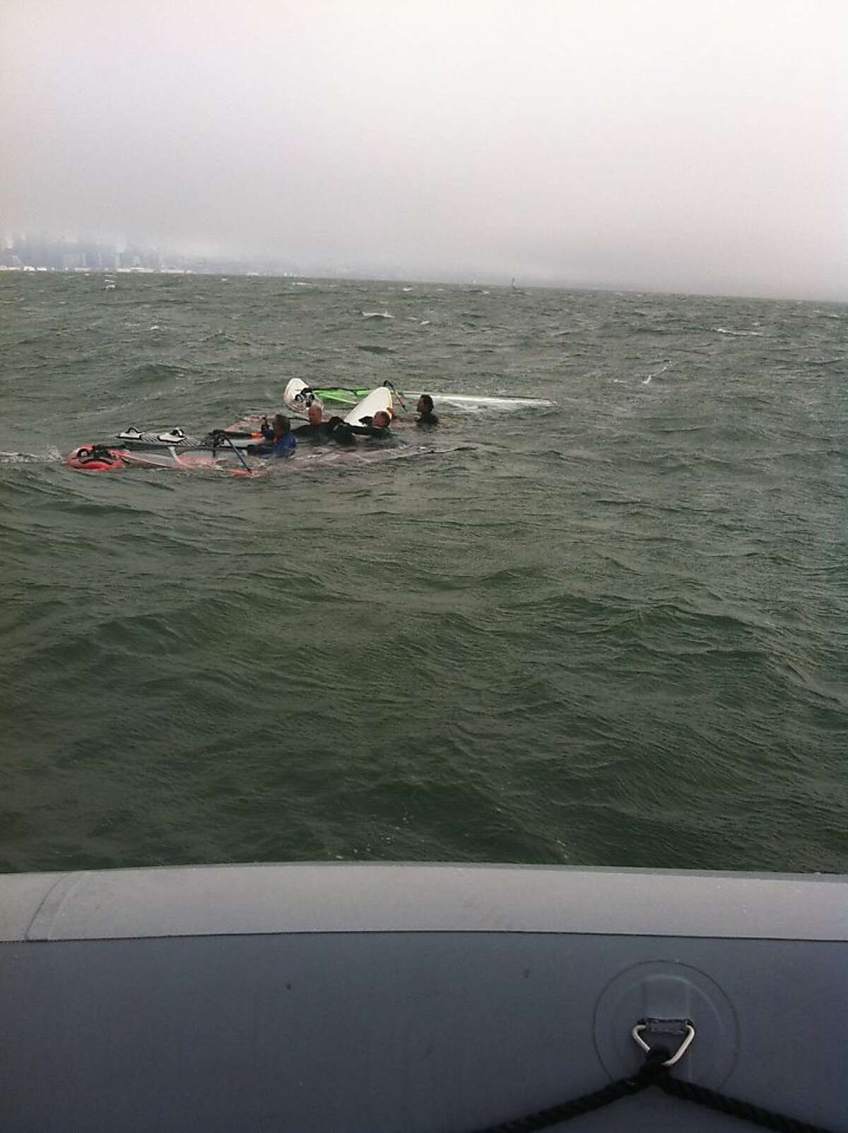 A group of windsurfers discovered and rescued a dog swimming in the bay Monday night, August 12, 2013.