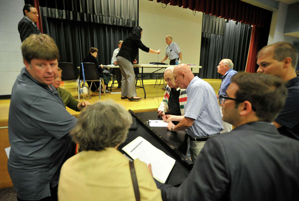 Residents sign up to speak before the public hearing in front of the Stamford Planning Board at Westover School in Stamford, Conn., on Tuesday, Aug. 13, 2013. The plan before the board is Building and Land Technology's proposal to shift a boatyard to Magee Avenue in order to make room for the hedge fund Bridgewater Associates to move into land on a peninsula on Bateman Way.