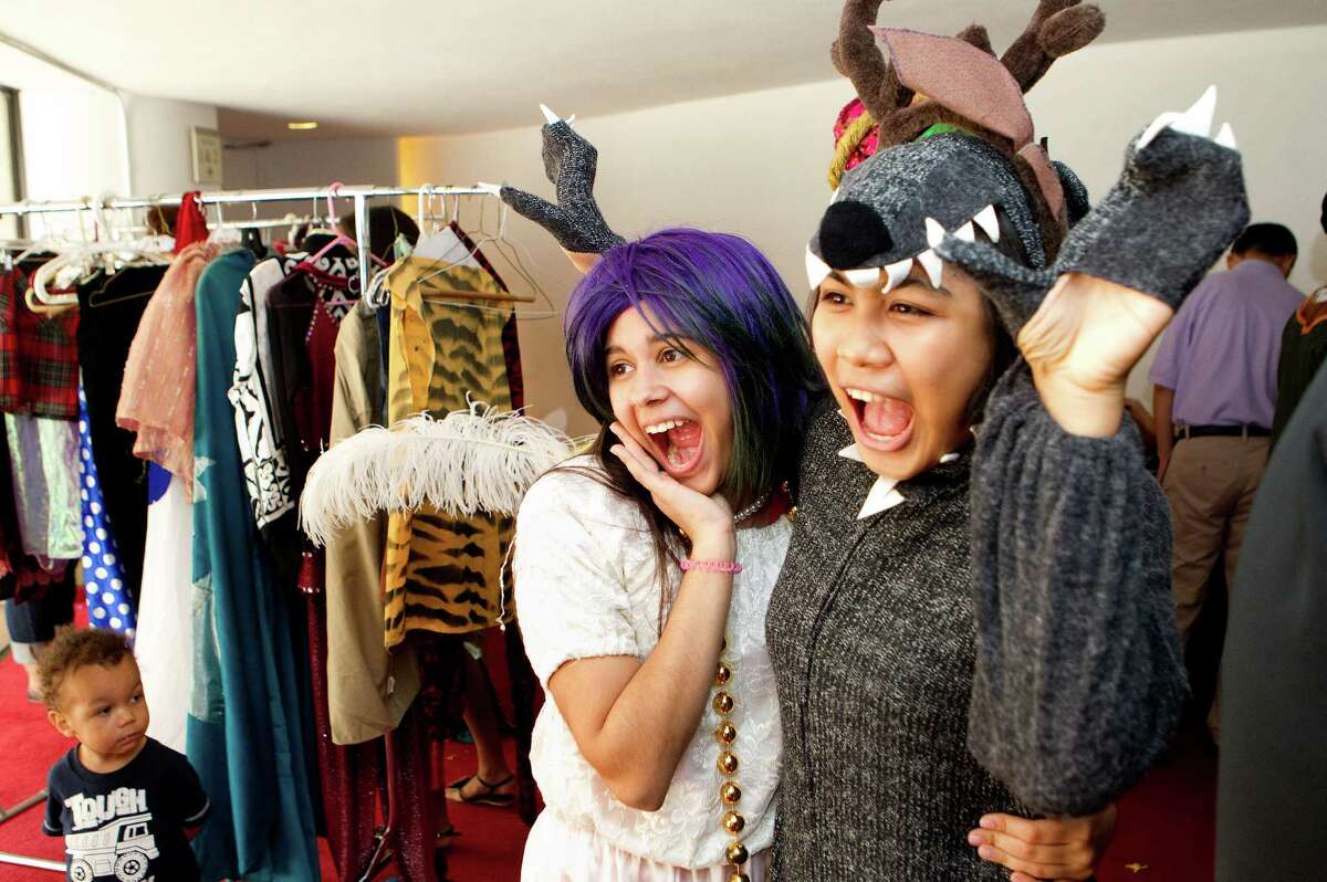 Andrea Bonnin, 16, left, and Fiang Boonyarat, 17, right, take a photo as they try on costumes during the 19th annual Theater District Open House, at Alley Theatre Sunday, Aug. 26, 2012, in Houston. The open house had different activities including backstage tours, live performances by professional and community entertainers and allowed attendees to try on costumes. It also allowed attendees to learn more about the arts and Houston's nine major performing arts organizations: Alley Theatre; Da Camera of Houston; Gexa Energy Broadway at the Hobby Center; Houston Ballet; Houston Grand Opera; Houston Symphony; Society for the Performing Arts; Theatre Under The Stars and Uniquely Houston. (Cody Duty / Houston Chronicle)