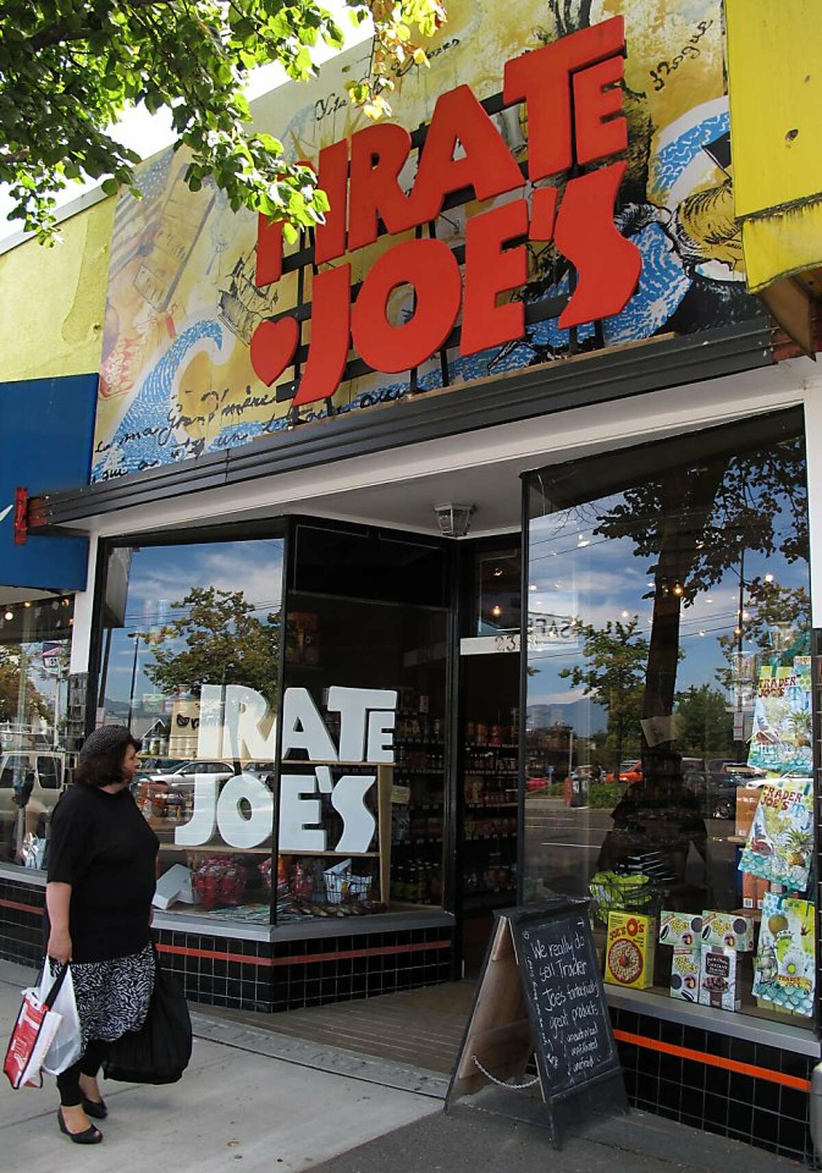 A shopper walks past the Pirate Joe's market in the Kitsilano neighborhood of Vancouver, B.C. on Wednesday, July 24, 2013. Mike Hallatt opened the shop, which resells Trader Joe's products, in 2012 and is now being sued by California-based Trader Joe's. Hallatt makes frequent trips to the United States to stock up on product during shopping sprees at Trader Joe's despite having his photo posted at most locations in Washington state.