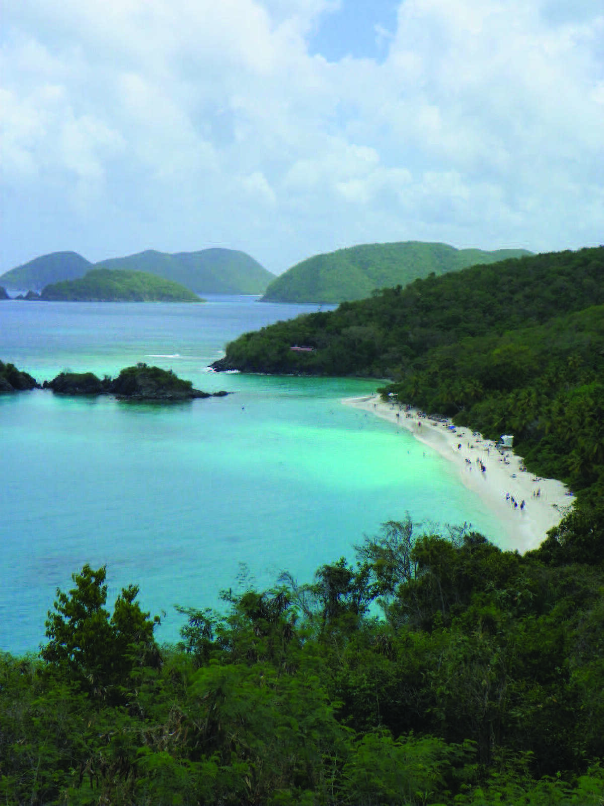 The turquoise water and white sandy beach of Trunk Bay can be enjoyed up close or from this overlook. Trunk Bay has one of the most popular beaches on the island of St. John. Below: Tropical plants surround the door to the Calypso Del Sol rental home in St. John.