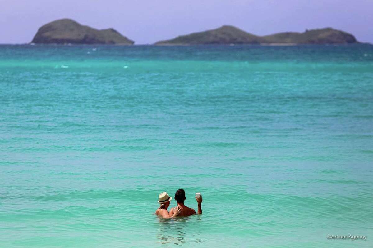 Over summer 2013, we asked Chronicle readers to send us their vacation photos. Keep clicking for ideas to think about while planning your next trip. This photo: A photographer snapped this picture of us while we were on our honeymoon in St. Barth's in June 2013. We were swimming at St. Jean beach and this was taken right after we saw a baby sting ray! Allison Ragland