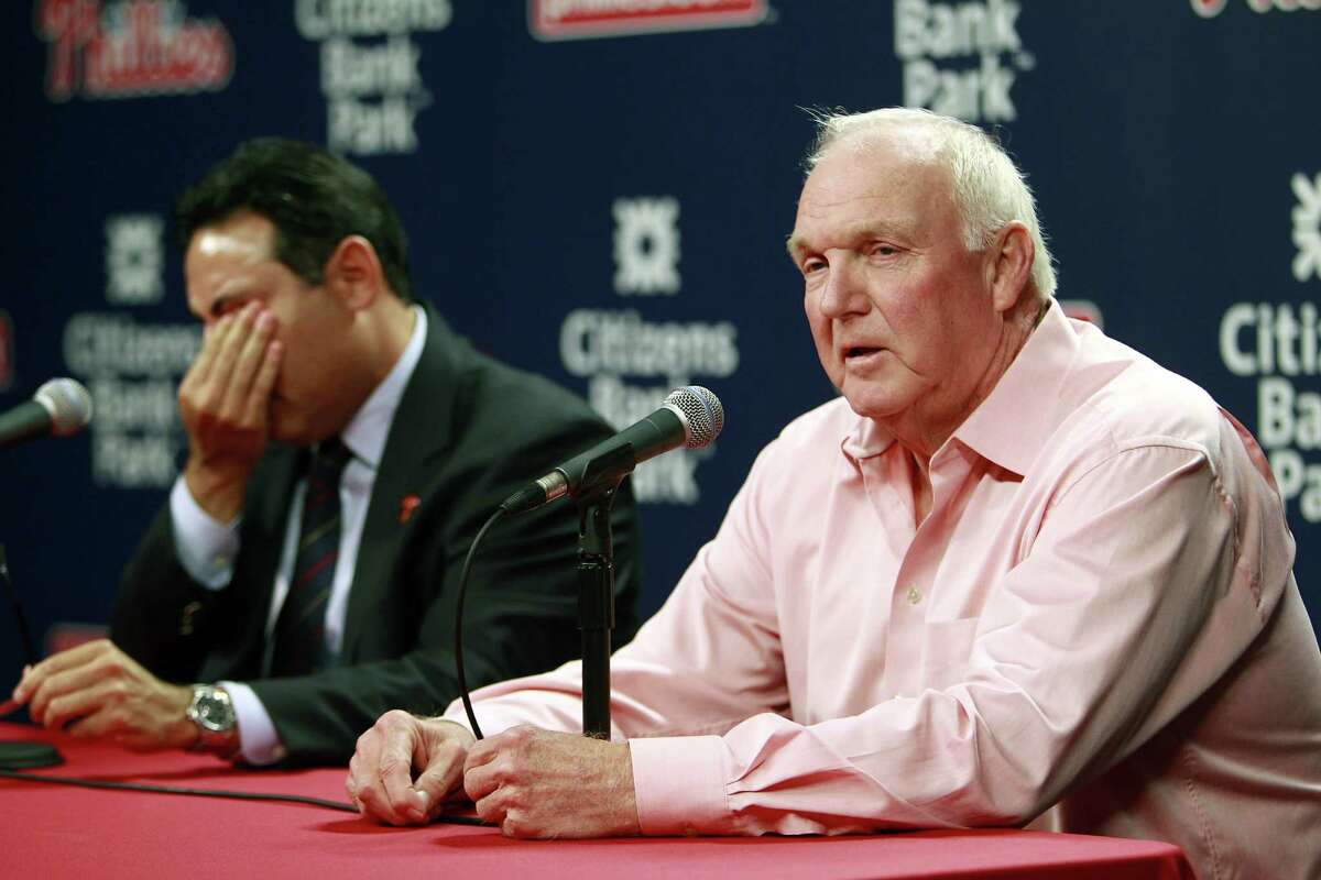 Phillies GM Ruben Amaro Jr. wipes his eyes as Charlie Manuel talks about being fired as the team's manager. Ryne Sandberg is the interim manager.