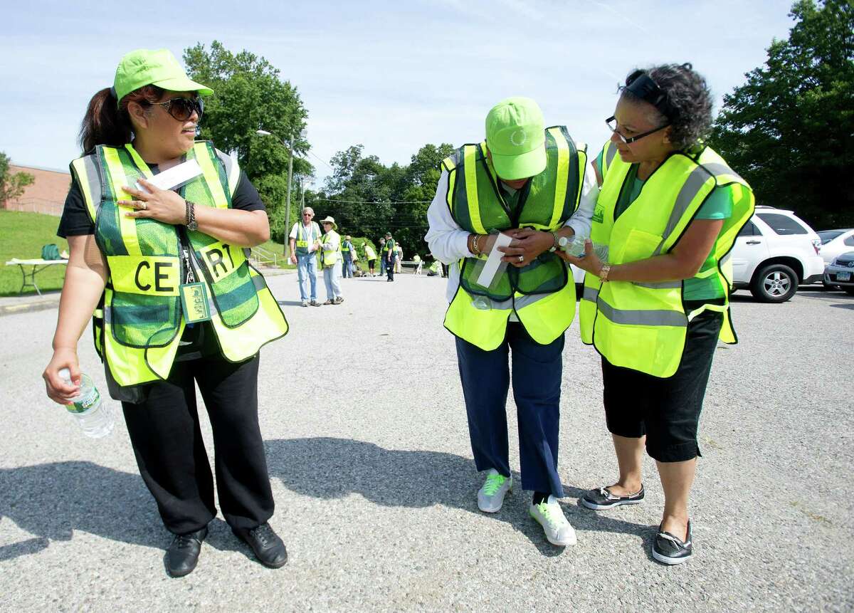 Bridgeport Community Emergency Response Team members Emma Perez, Elena Moreno and Nilda Paris participate in a practice drill simulating a fire at an office complex at Roxbury Elementary School in Stamford, Conn., on Saturday, August 17, 2013.