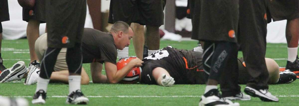 Cleveland Browns offensive lineman Ryan Miller is attended to after he suffered a concussion during NFL football training camp on July 27 in Berea, Ohio.