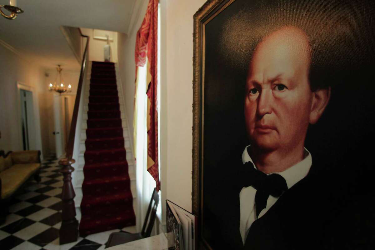 A portrait of Menard hangs in his historical home on the island, where ghosts of children and a spurned lover have purportedly been sighted.