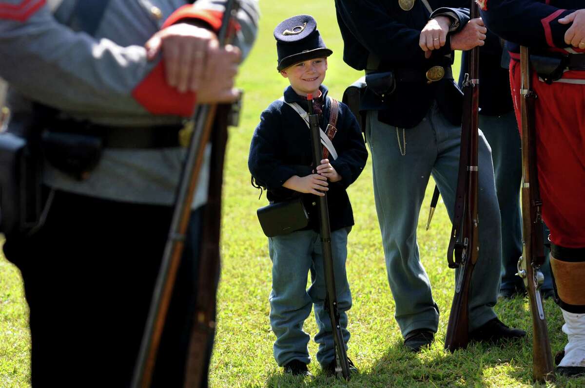 Hunter Brown, 6, of North Adams, Mass., a reenactor with the 123rd New York, grins for a picture as he stands at parade rest during Civil War Heritage Days on Saturday, Aug. 17, 2013, at Schuyler Flatts Cultural Park in Colonie, N.Y. The encampment continues Sunday from 10 a.m. to 4 p.m. (Cindy Schultz / Times Union)