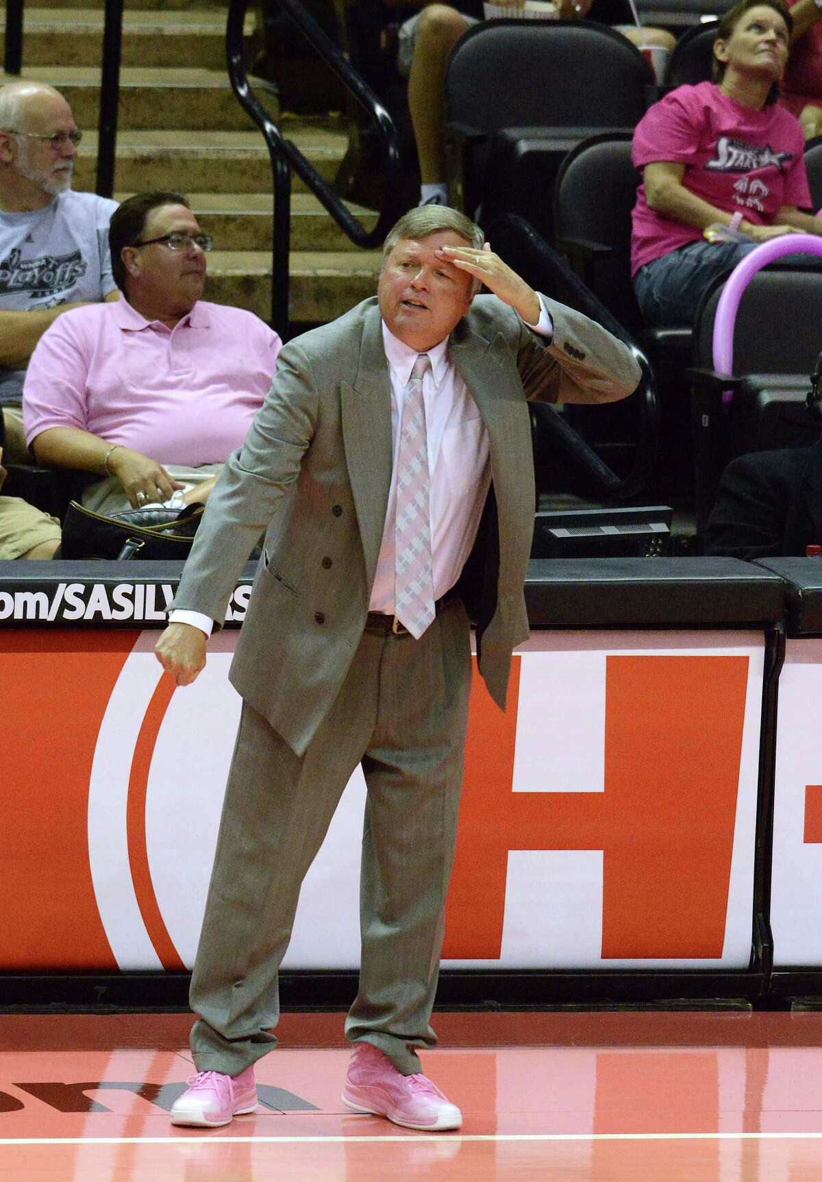 Head coach Dan Hughes of the San Antonio Silver Stars shouts instruction to his team while wearing pink basketball shoes to mark Breast Health Awareness Night for the WNBA at the AT&T Center on Saturday, Aug. 17, 2013.