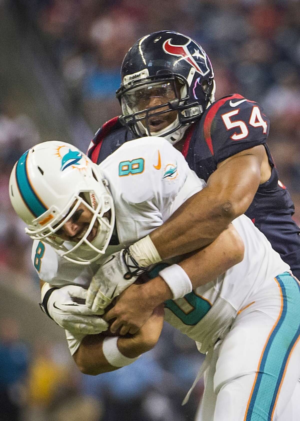 Texans linebacker Trevardo Williams sacks Dolphins quarterback Matt Moore.