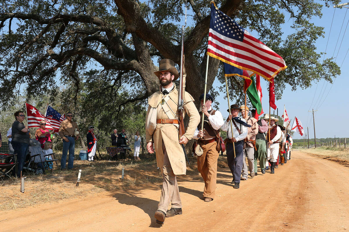 Re-enactors line up for a three-volley salute during the 200th anniversary of the Battle of Medina on Old Applewhite Road in Atascosa County.