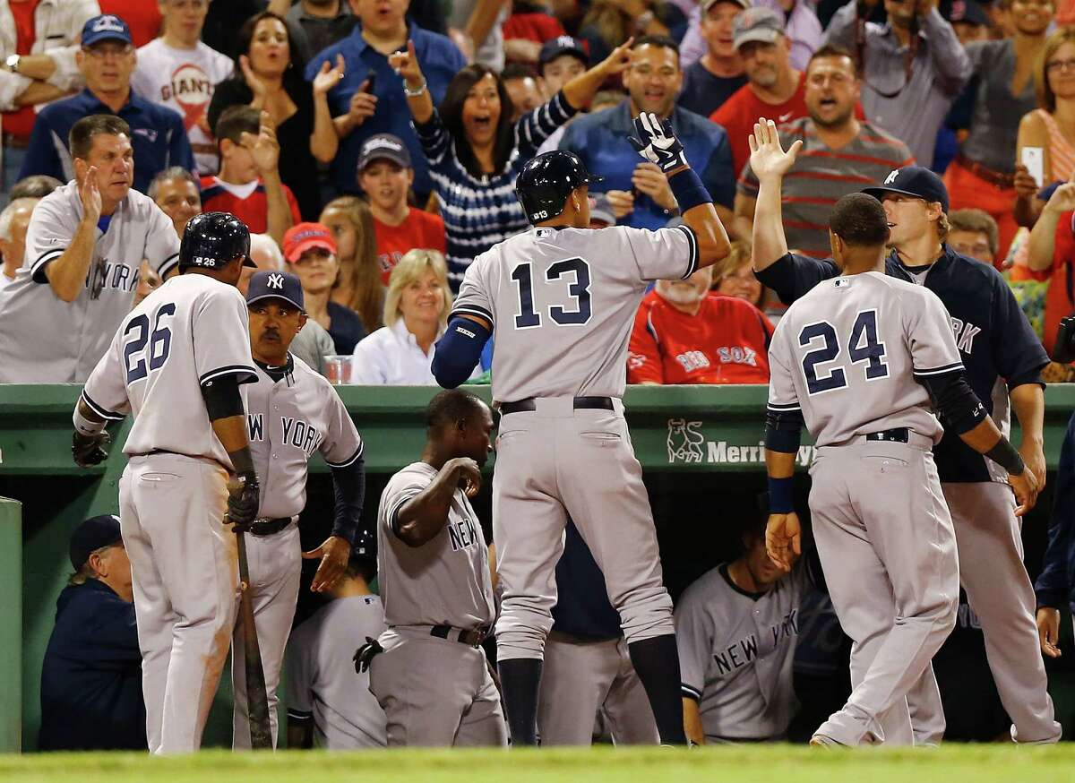 BOSTON, MA - AUGUST 18: Alex Rodriguez #13 of the New York Yankees celebrates with teammates in the dugout after hitting a solo home run in the fifth inning off of Ryan Dempster #46 of the Boston Red Sox during the game on August 18, 2013 at Fenway Park in Boston, Massachusetts. (Photo by Jared Wickerham/Getty Images) ORG XMIT: 163495076