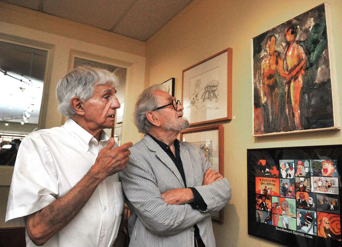 Joseph Farris, left, and Frederick Carpenter, discuss Carpenter's painting," Lovers," at the opening reception of The Artists of Plain Jane's Art Show, in Bethel, Conn. Sunday, Aug. 18, 2013.