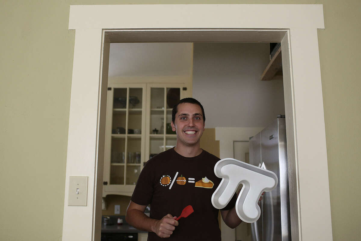 At his San Antonio home, Garrett Heath holds a pi pan he created for making pi-shaped pies. He was helped by Kickstarter, a “crowd-funding” website whose users gave him $7,848, allowing him to place an order for hundreds of the pans.
