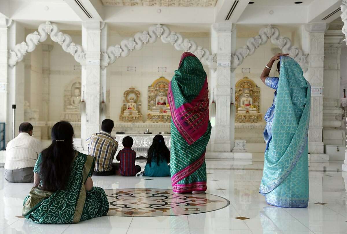 In this photo taken Friday, Aug. 16, 2013, Jains pray at the Jain Center of Southern California (JCSC) in Buena Park, Calif. The ancient Indian religion of Jainism, a close cousin of Buddhism, has a strict adherence to nonviolence that forbids eating meat, encourages days of fasting and places value on even the smallest of insects. In India, Jains account for about 1 percent of the population and the community in the U.S. counts about 150,000 followers. (AP Photo/Nick Ut)