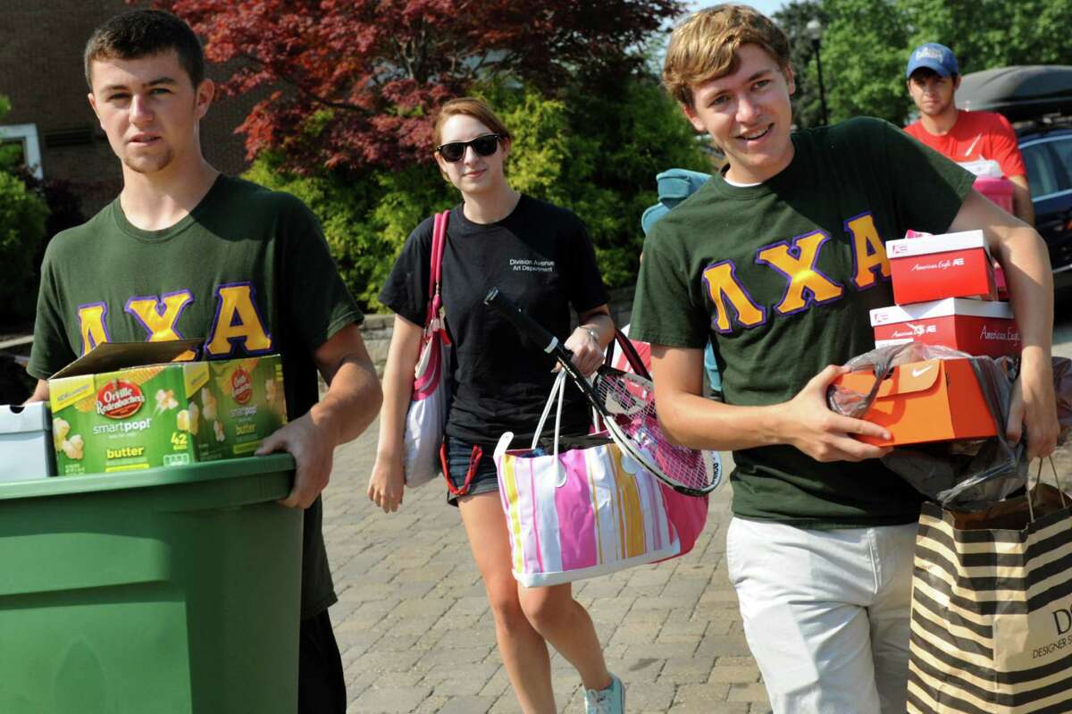 Freshman Theresa Winkler, 18, of Long Island, center, gets help moving into Barton Hall on Tuesday, Aug. 20, 2013, at Rensselaer Polytechnic Institute in Troy, N.Y. Assisting her are Lambda Chi Alpha fraternity brothers Zach Wolfgang, 18, left, and Chris Volk, 21, right. (Cindy Schultz / Times Union)