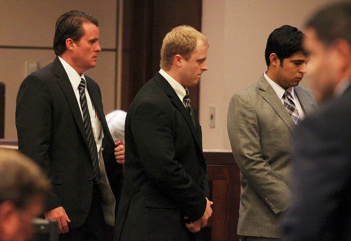 Jeffrey Eugene Theisen (center) walks away from the judge's bench with his attorneys as the jury returned with guilty conviction of intoxication manslaughter and handed Theisen a 13-year sentence for the death of Christina Renee Flores at the 399th District Court on Tuesday, Aug. 20, 2013. Theisen crashed into Flores in 2011 by going the wrong way on Interstate 37 while intoxicated.