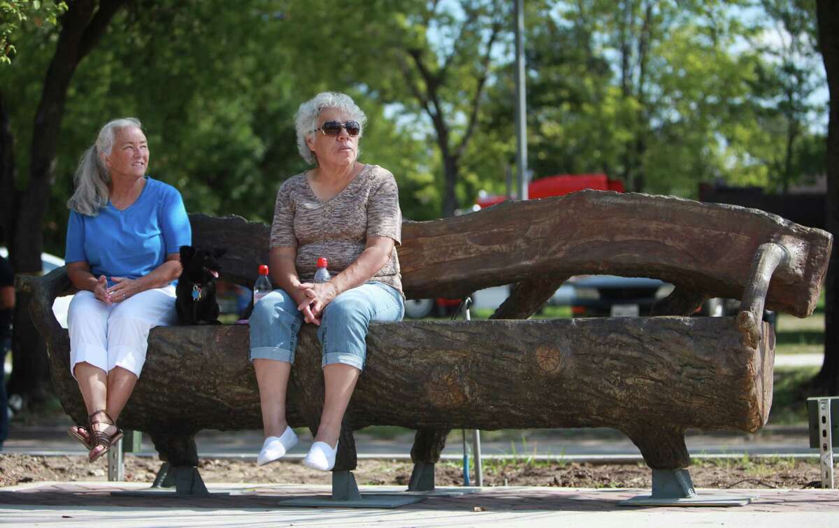 Julia Pendleton, her dog Suzi Q, and Hope Barley sit in the shade on the newly installed furniture at the Navigation Boulevard Esplanade.