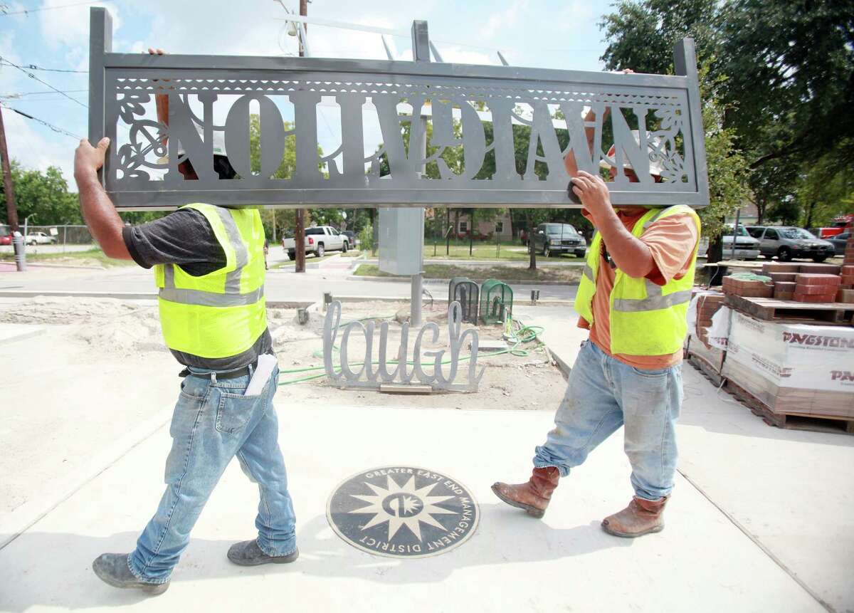 Workers install street art signs to their final location along the Navigation Boulevard Esplanade on Tuesday, Aug. 20, 2013, in Houston. The esplanade along Navigation Boulevard between N. St. Charles Street and N. Paige Street is meant to be an attraction for local residents and tourists of the East End.