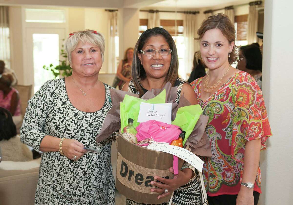 Christina Smith-Simmons of Realty Associates, center, won a spa treatment basket from Becca Phillips, left, sales counselor of Highland Homes and Kristi Steward, director of marketing for Harmony, a project of The Johnson Development Corp.